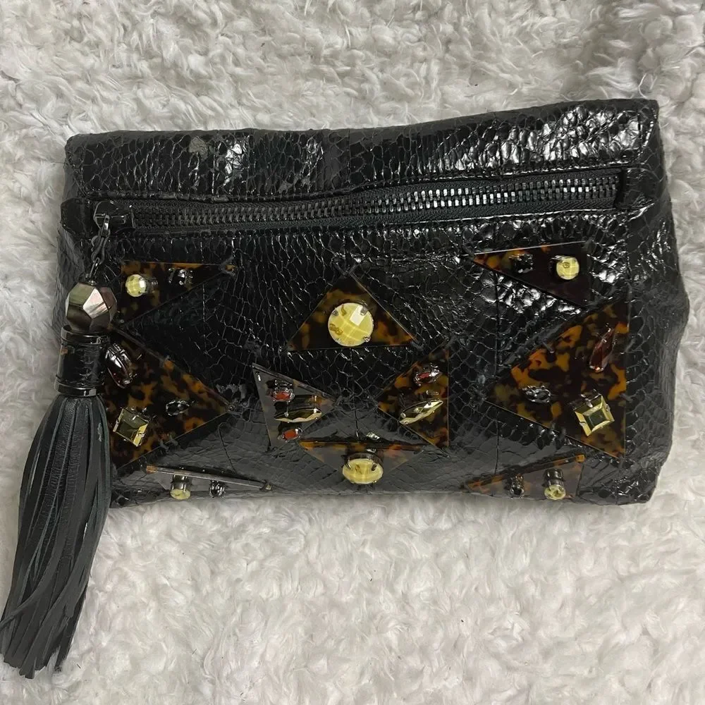 Rafe Black patent snake skin print clutch embellished with jewels and tassel .